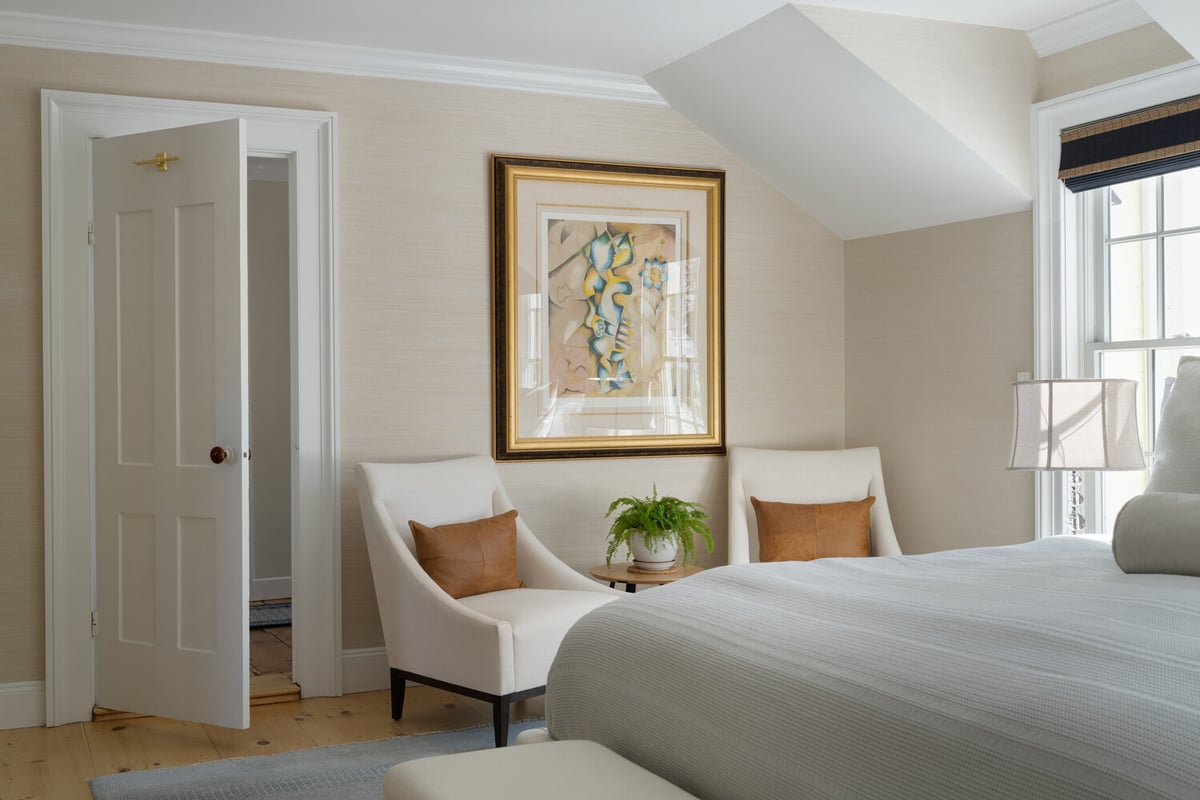 cozy custom home bedroom seating area with natural light and decor by Craft Design + Build in Madison, CT