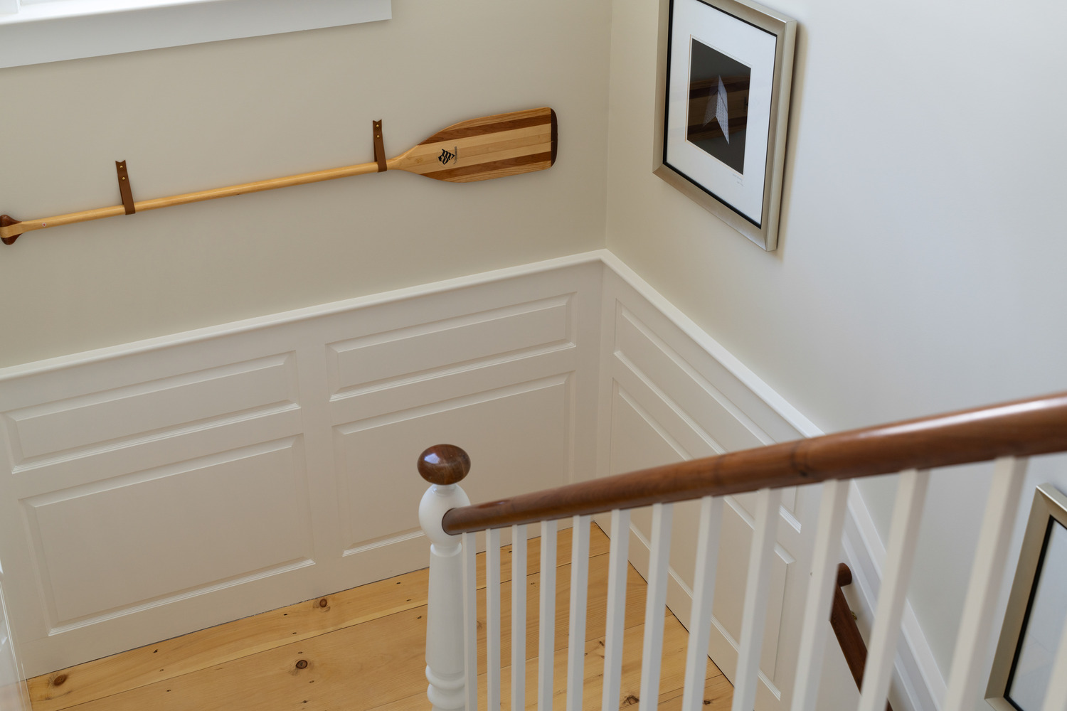 custom home stair landing with wood railing and wall paneling by Craft Design + Build in Durham, CT custom home stair landing with wood railing and wall paneling by Craft Design + Build in Durham, CT