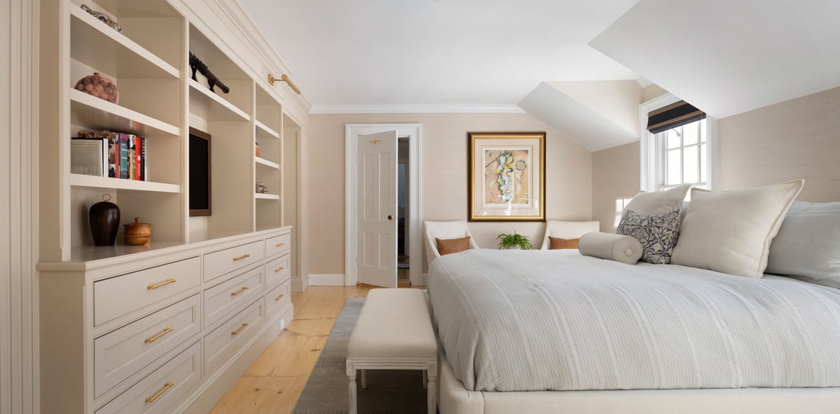 large custom home bedroom with neutral palette and integrated storage by Craft Design + Build in Lyme, CT