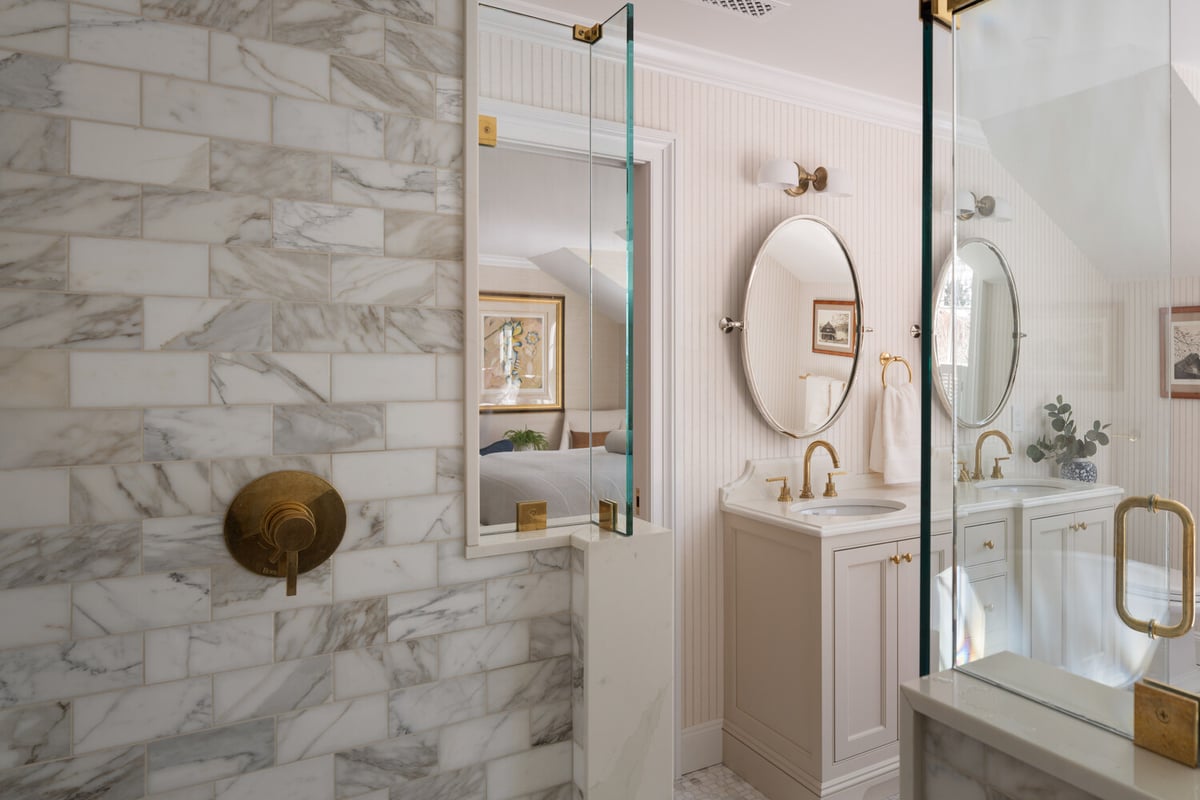 marble walk-in shower with glass enclosure in custom home bathroom by Craft Design + Build in Deep River, CT