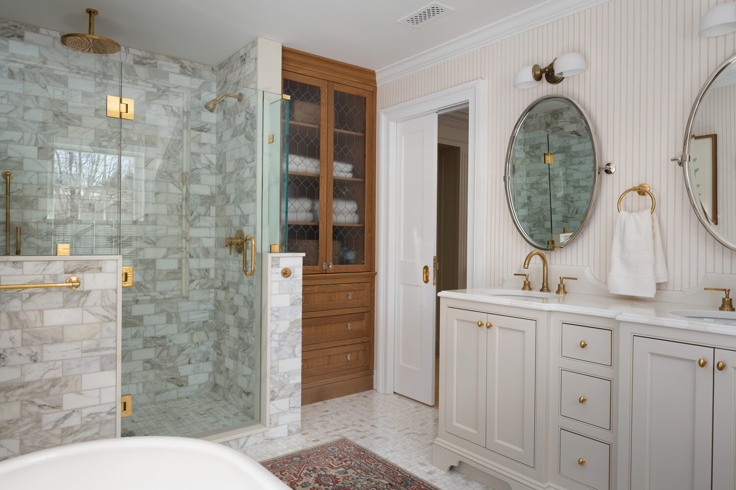 spacious custom home bathroom with glass shower and classic vanity by Craft Design + Build in Haddam, CT