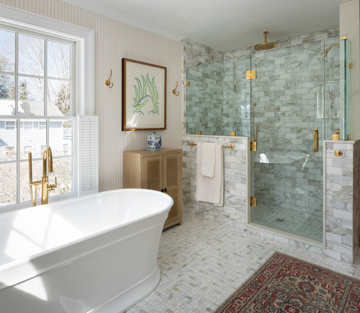 wide view of custom home bathroom with tub and glass shower by Craft Design + Build in Guilford, CT