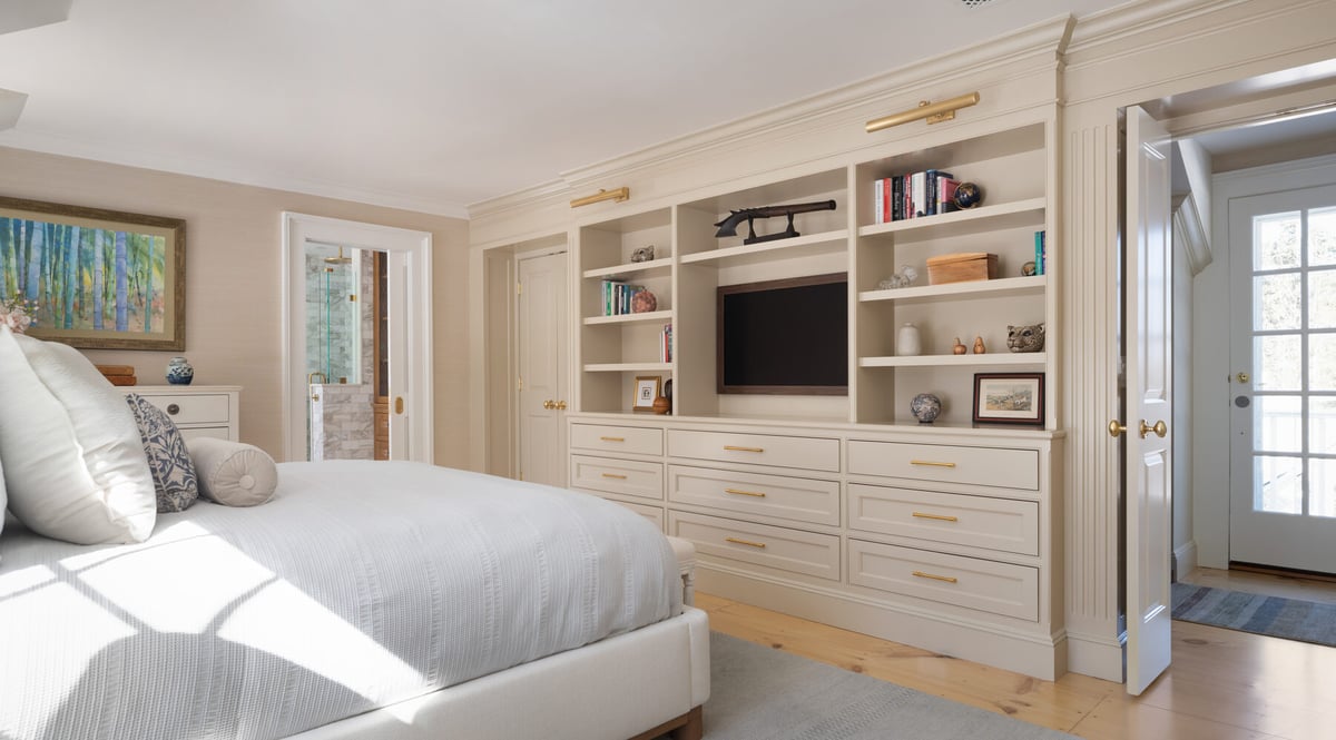 wide view of custom home bedroom with integrated storage and seating area by Craft Design + Build in Old Saybrook, CT