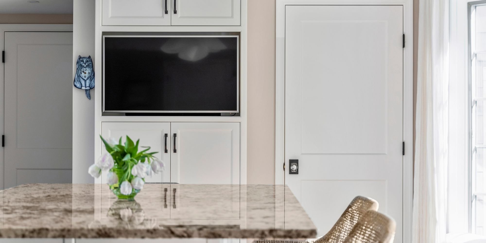 sleek tv integration with kitchen cabinets in an essex ct remodel