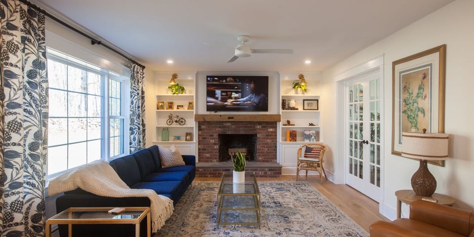 home addition in essex connecticut with brick fireplace, seating area, and french doors