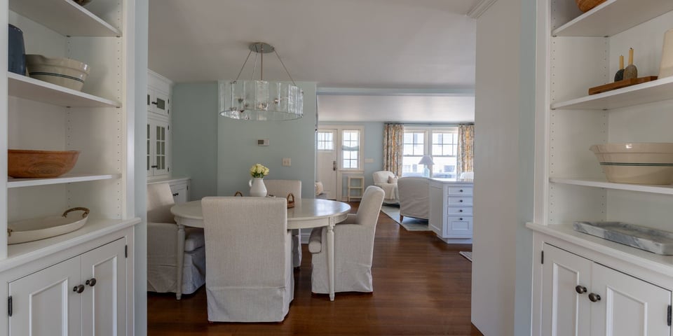 coastal home remodel with white custom cabinets and sea foam walls