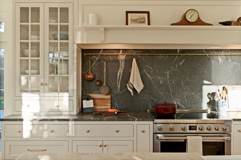 statement black marble kitchen counter and backsplash with traditional white cabinets in a ct kitchen remodel