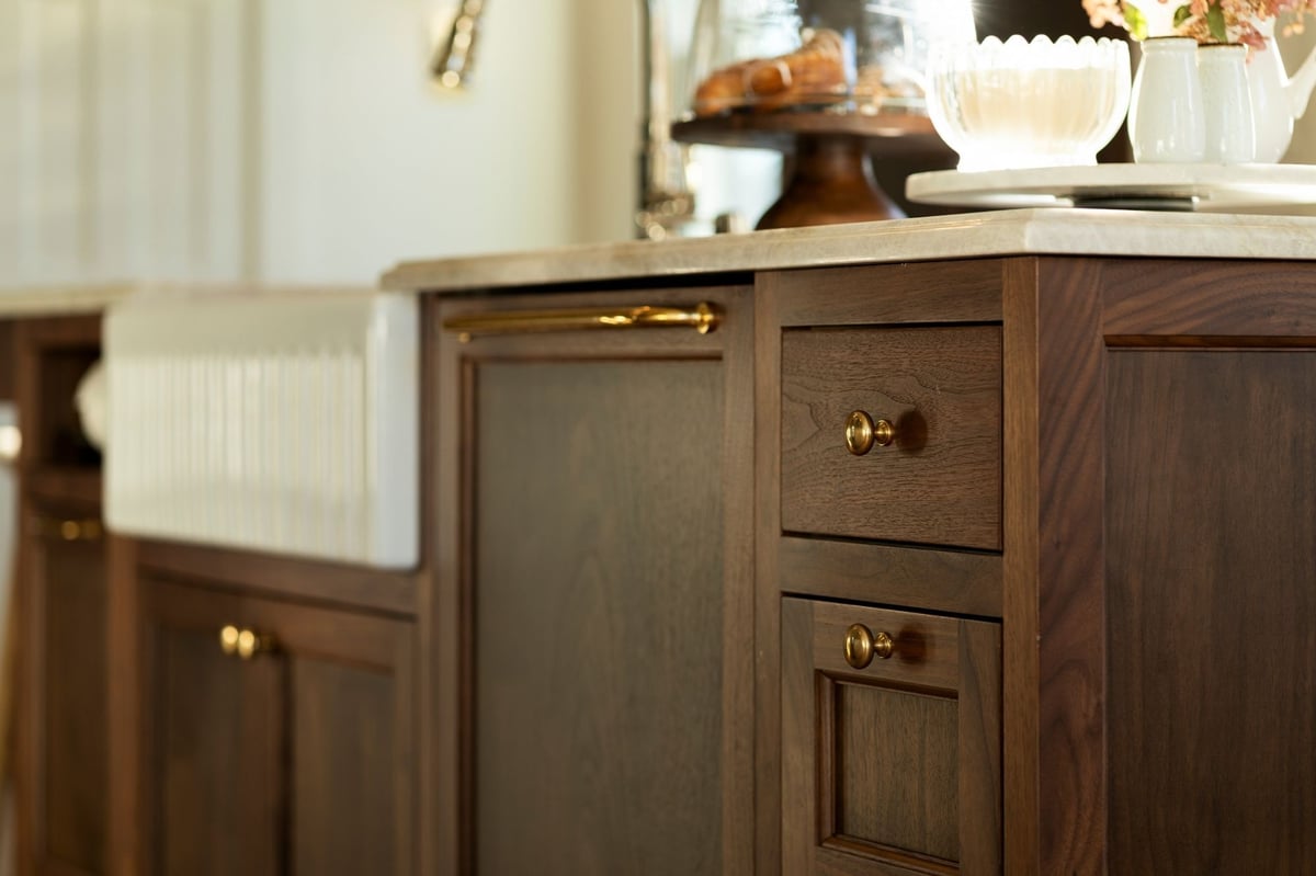 wooden kitchen cabinets with gold handles and a marble countertop in a ct kitchen renovation