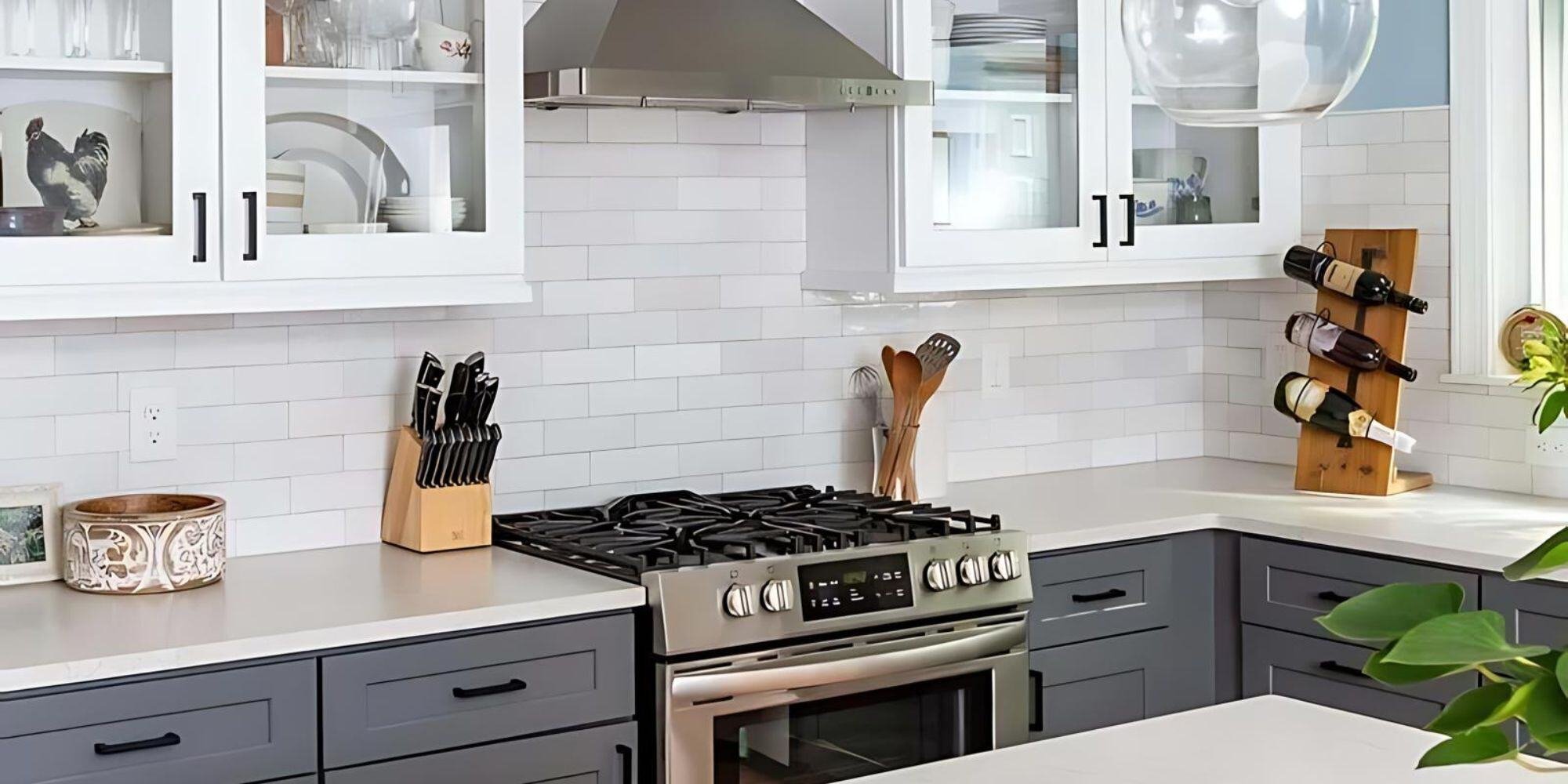 Elegant kitchen with stainless steel range and gray cabinetry in an Essex home remodel by Craft Design + Build-1