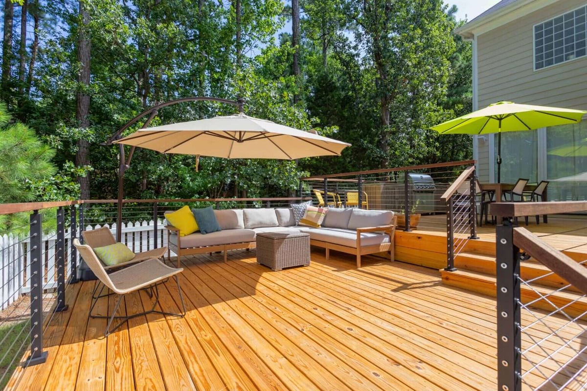 Elevated deck with seating and greenery in Essex, Connecticut, crafted by Craft Design + Build