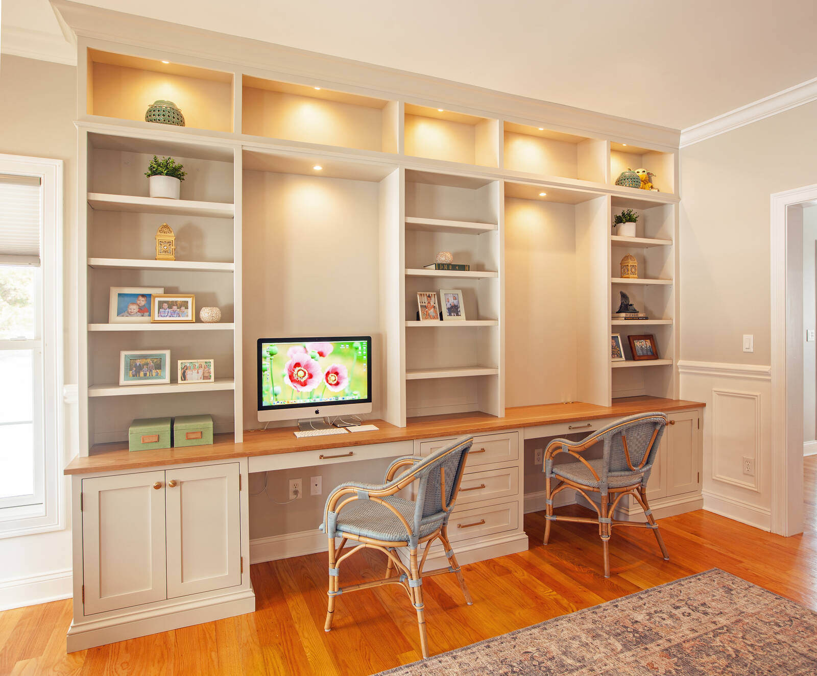 Custom home office with built-in shelves and desk by Craft Design and Build in Essex, Connecticut