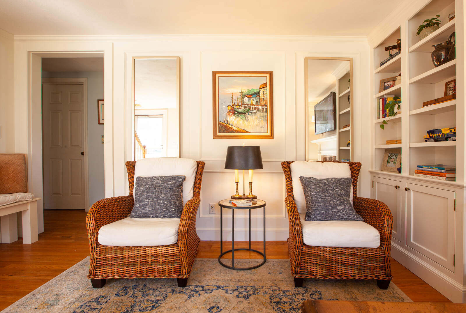 Living room with brick fireplace and arched doorway by Craft Design and Build, Essex, Connecticut