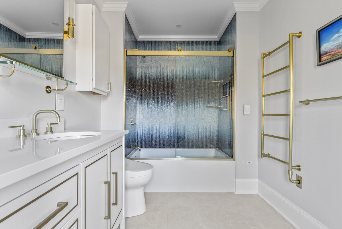 Contemporary bathroom with blue and gold shower by Craft Design Build in Essex, CT