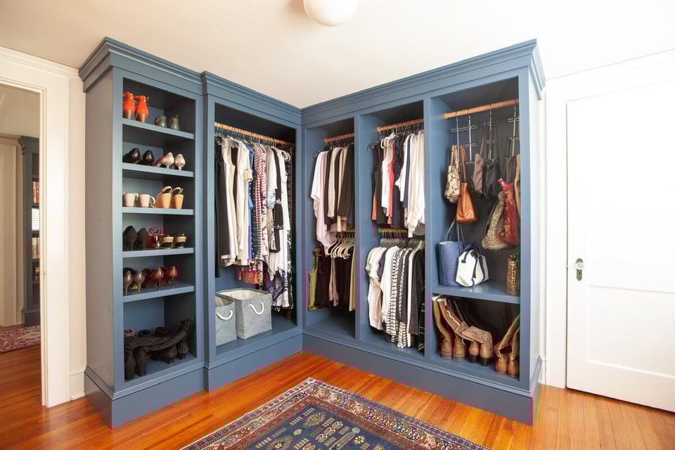 Custom blue walk-in closet in a home remodel by Craft Design Build in Essex, CT