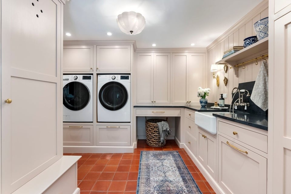 Custom laundry room remodel with white appliances and beige cabinetry, Craft Design Build, Essex, CT