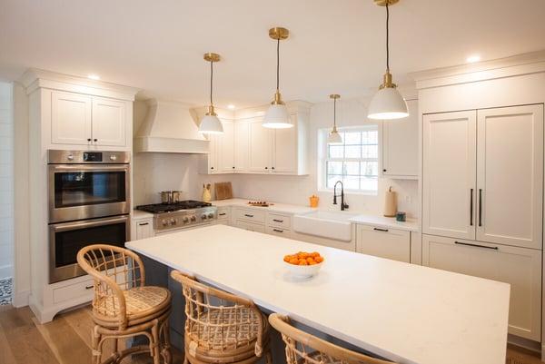 Stylish kitchen with double ovens and large island by Craft Design Build in Essex, CT