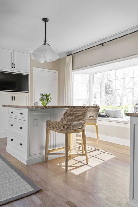 Modern kitchen nook with island seating and a large window by Craft Design Build in Essex, CT