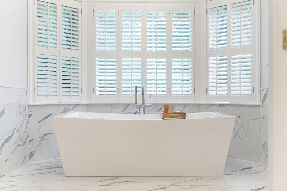 Luxurious bathroom with a freestanding bathtub and marble flooring, Craft Design Build, Essex, CT