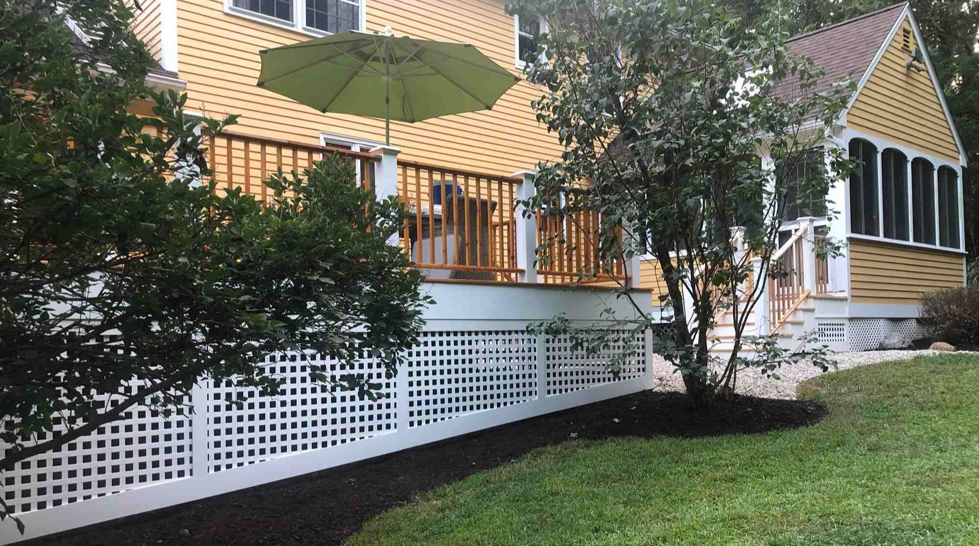 Side view of custom deck and garden by Craft Design Build in Essex, CT