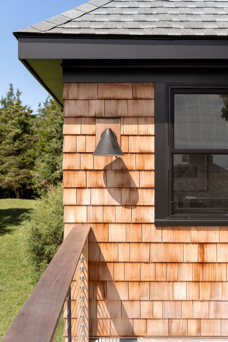 house addition cedar shingles with black trim and barn light guilford ct
