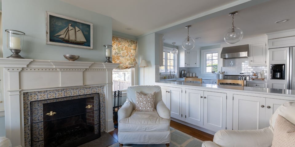 Home remodel on the Connecticut shoreline with all white kitchen, custom fireplace, and coastal interior design style