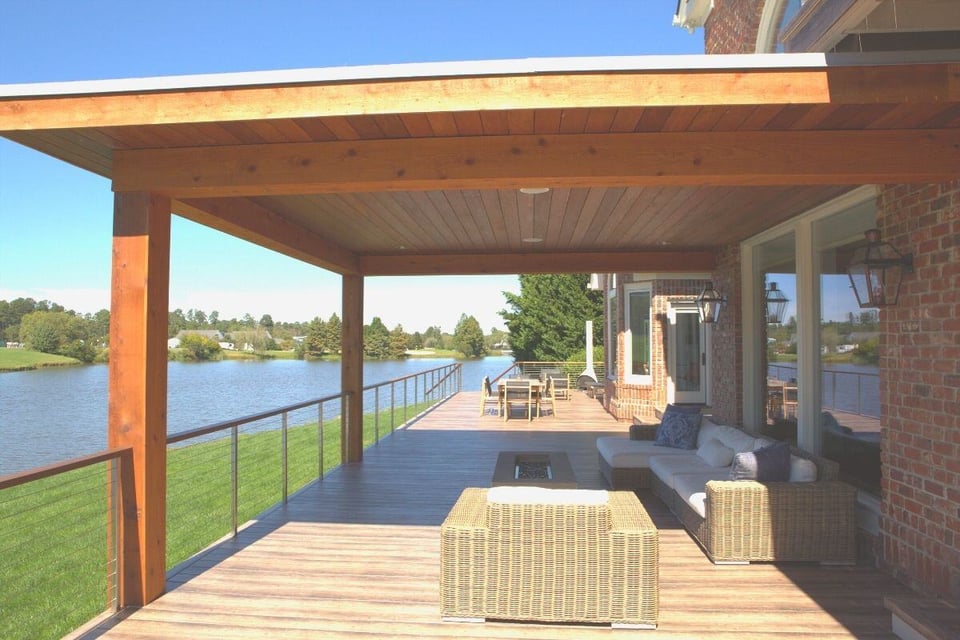 Lakefront patio deck remodel with wooden ceiling and modern furniture by Craft Design + Build, Essex, Connecticut