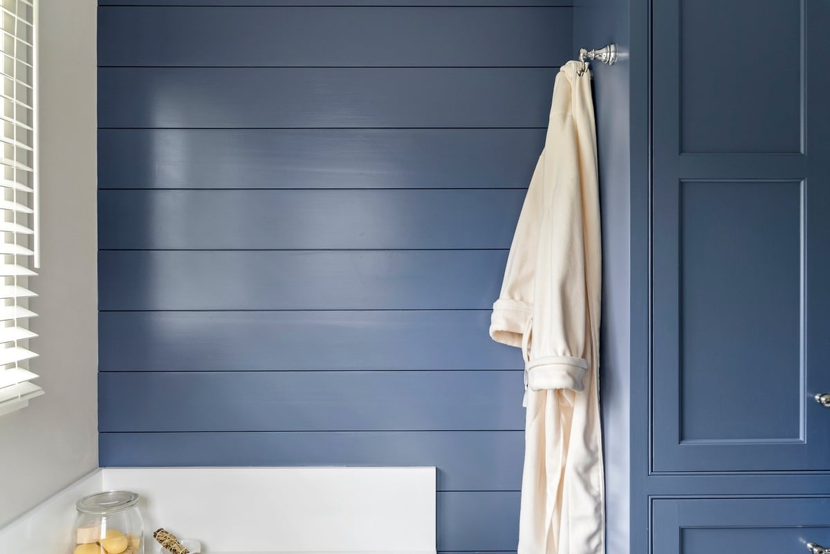 Navy blue shiplap wall with robe hook in Essex Primary Bathroom by Craft Design + Build, Essex, Connecticut