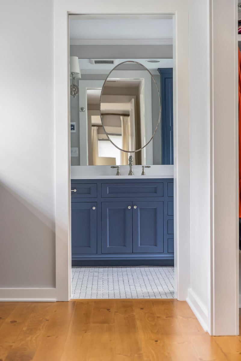 Stylish blue vanity and mirror in Essex Primary Bathroom remodel by Craft Design + Build, Essex, Connecticut