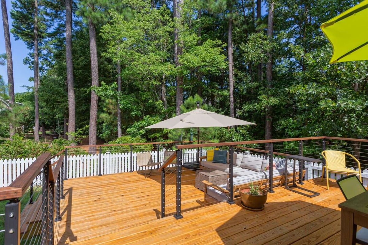 Stylish deck renovation in Essex, Connecticut, featuring a comfortable seating area, by Craft Design + Build