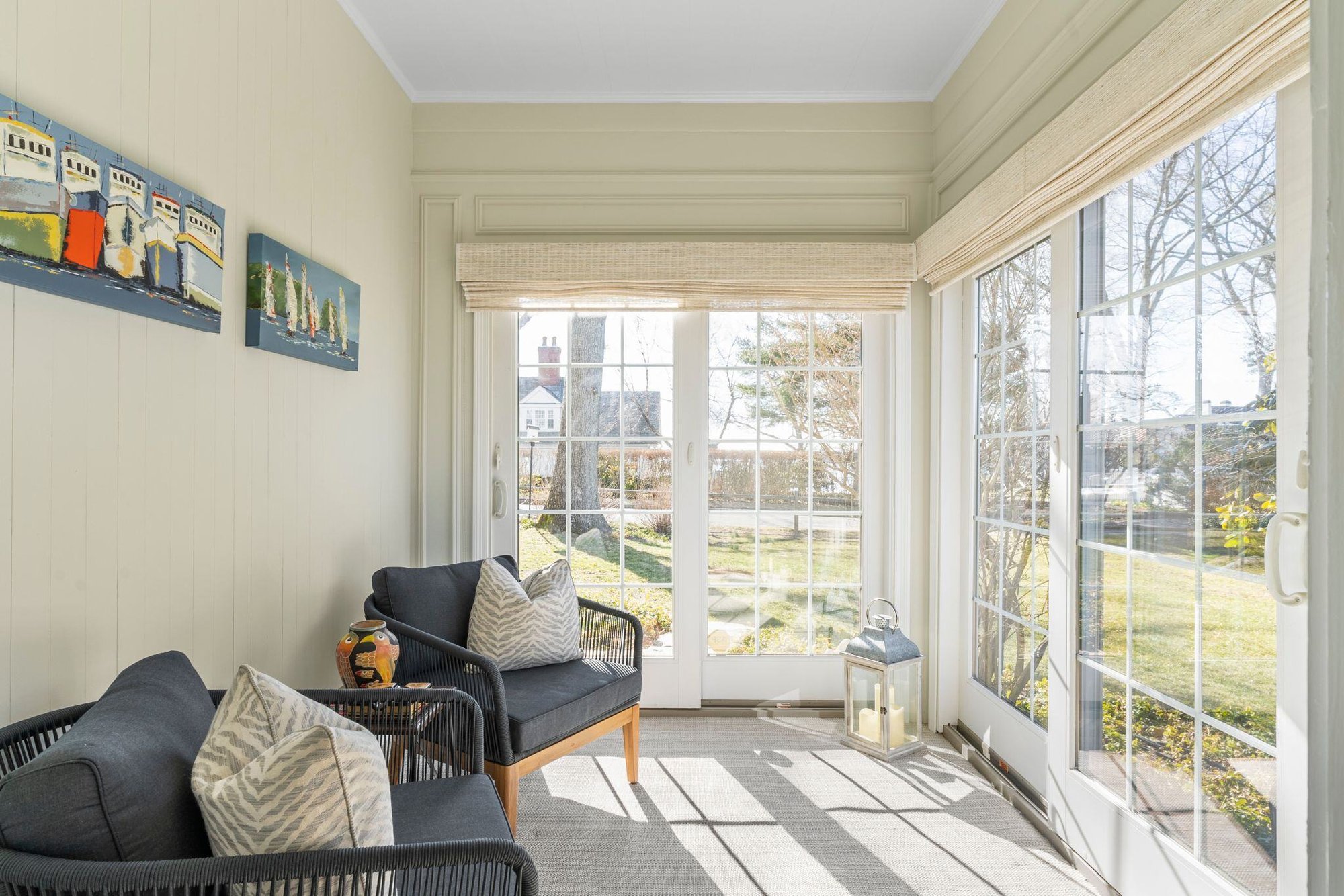 Essex Connecticut sunroom with white sliding doors and coastal interior design