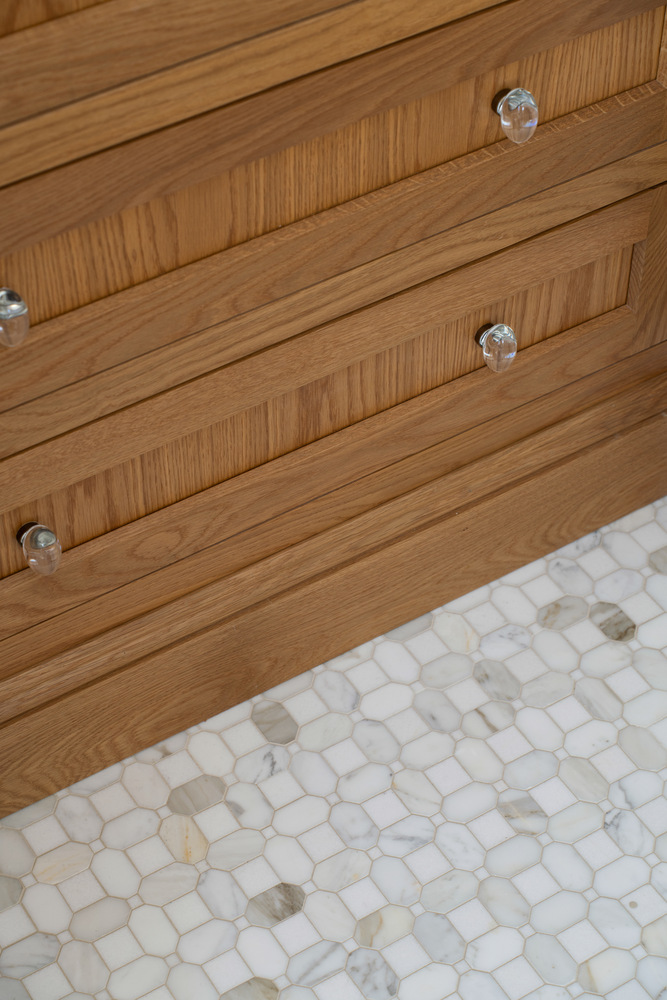 detailed custom home bathroom drawers with natural wood finish and mosaic tile floor by Craft Design + Build in Guilford, CT