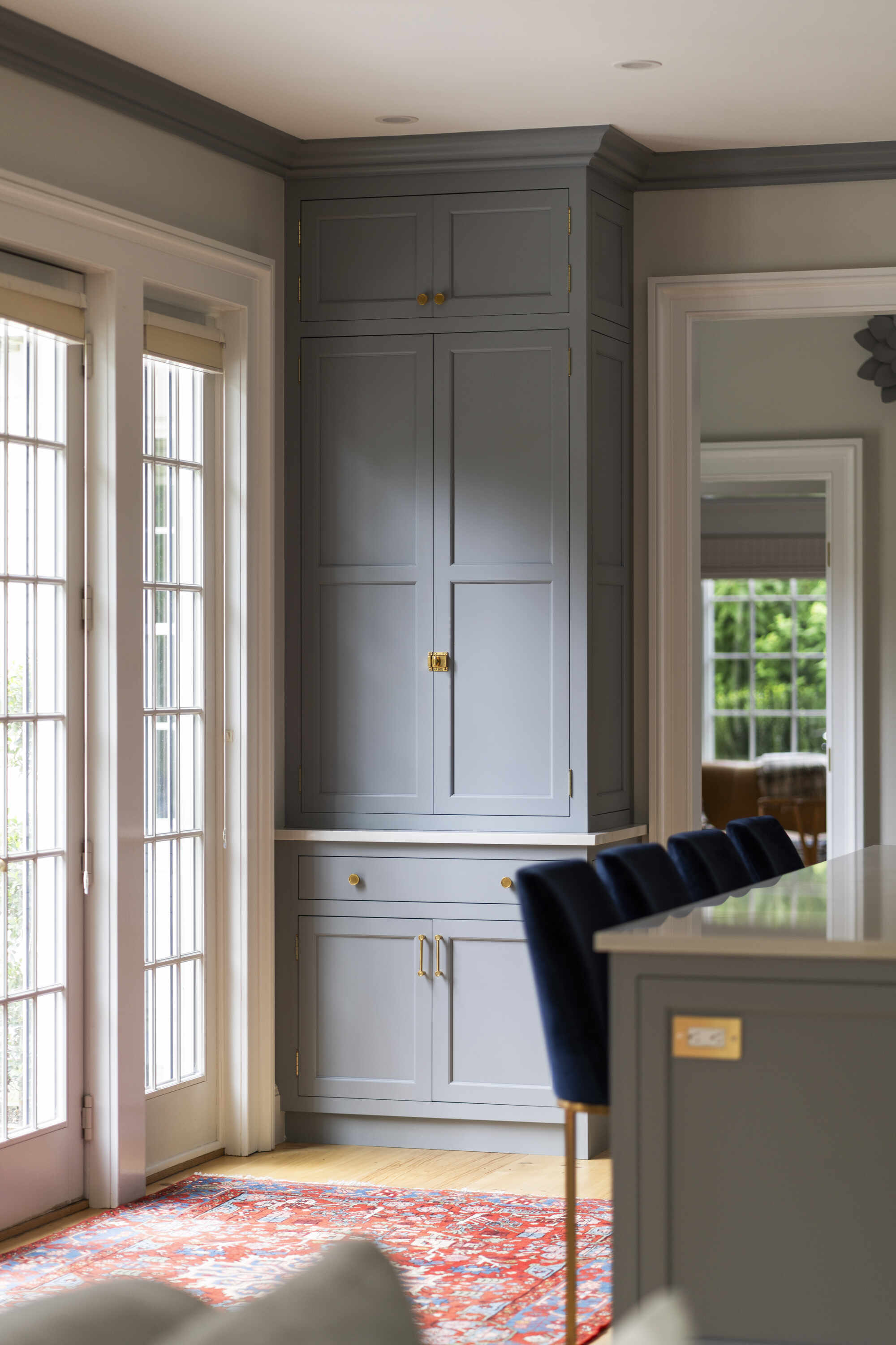 Tall grey cabinets in a remodeled kitchen by Craft Design and Build in Essex, Connecticut