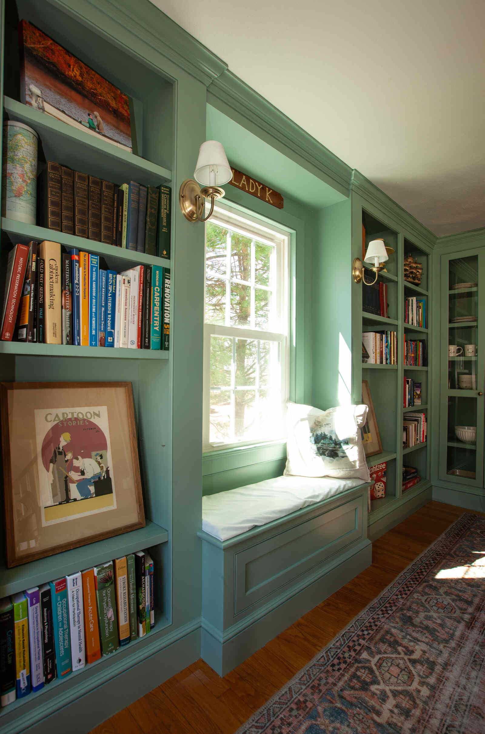 Built-in bookshelf and window seat in a custom home by Craft Design and Build, Essex, Connecticut