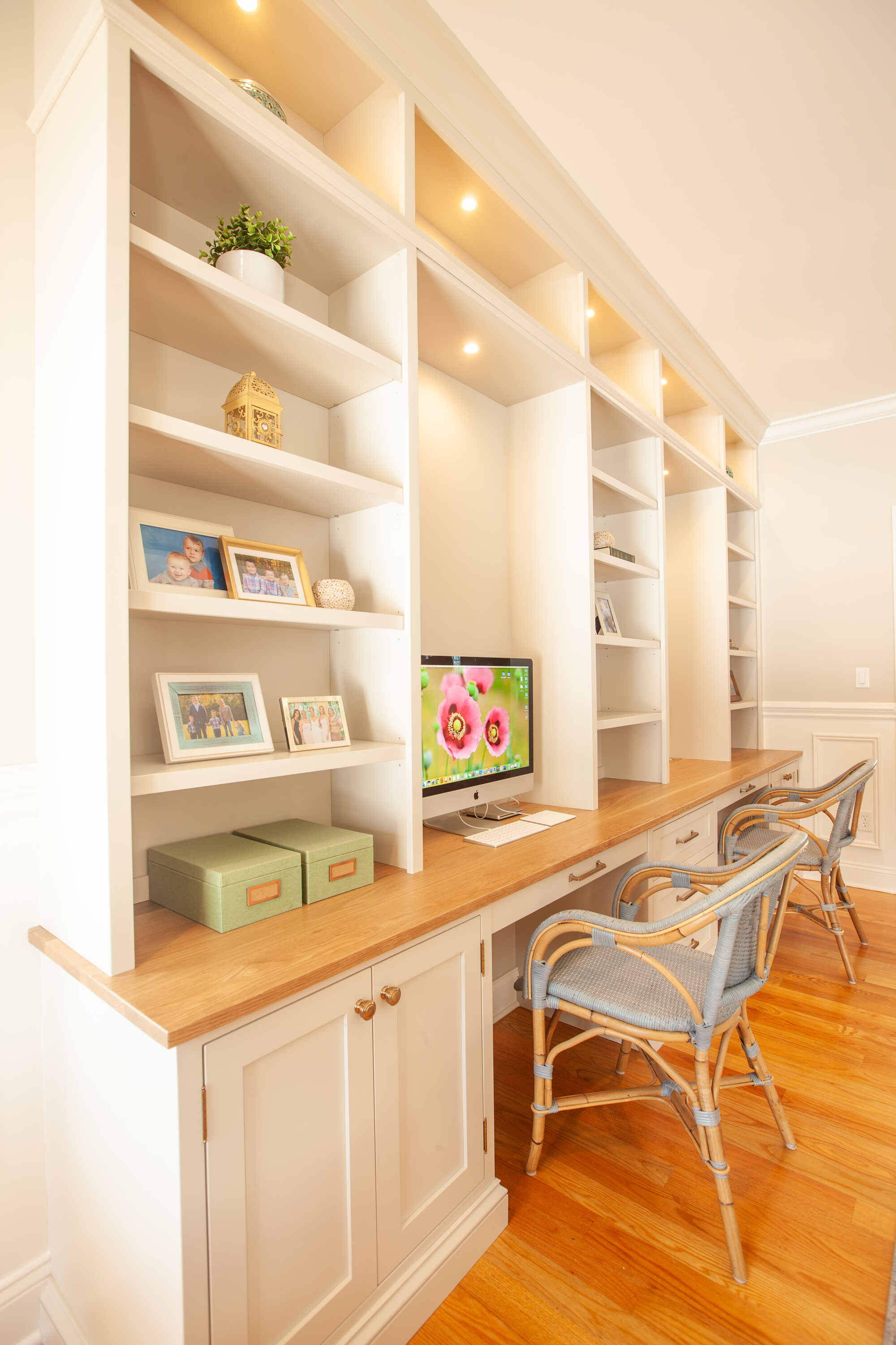 Home office renovation with custom-built shelves and desk by Craft Design and Build in Essex, Connecticut