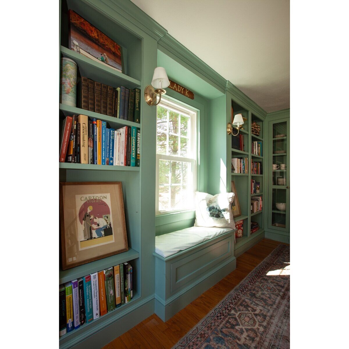 Custom built-in bookcase with window seat in a home remodel by Craft Design Build in Essex, CT