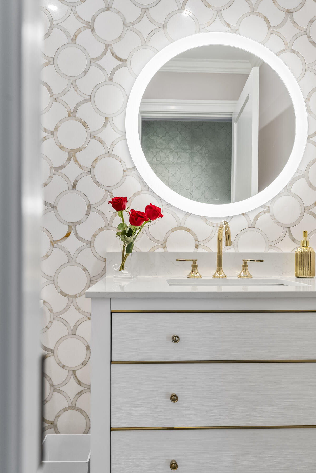 Luxurious Essex, CT bathroom remodel by Craft Design Build with gold fixtures and red roses