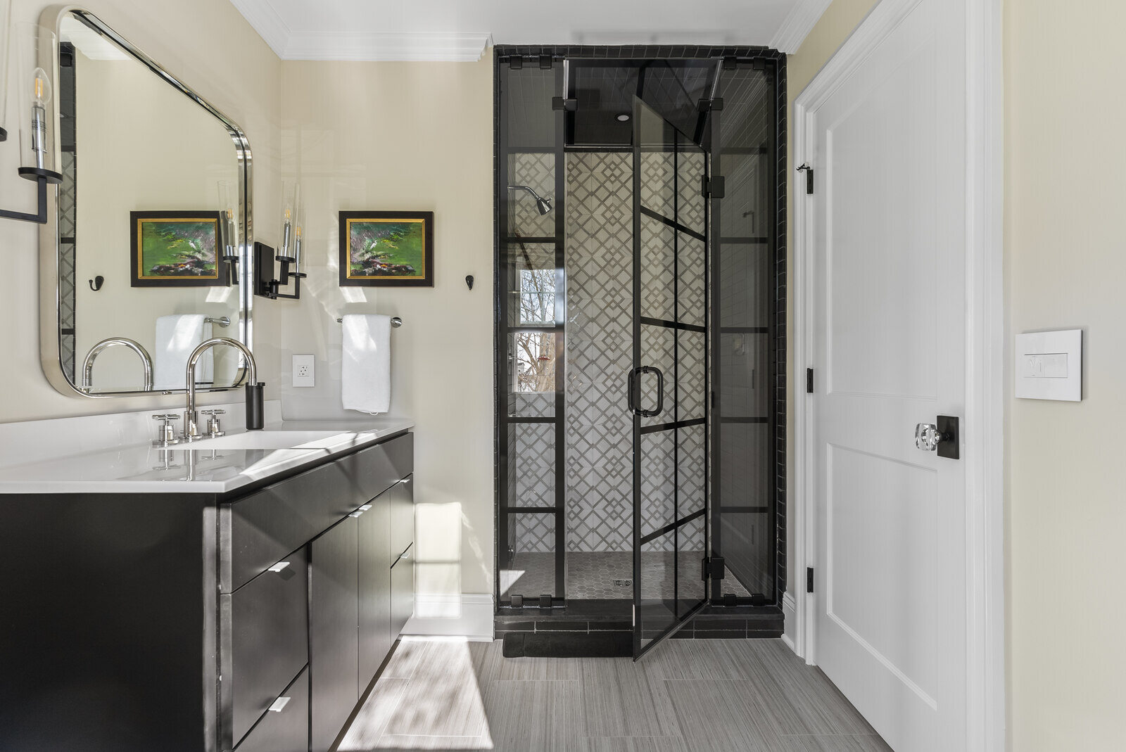 Modern bathroom remodel with black vanity and glass shower by Craft Design Build in Essex, CT