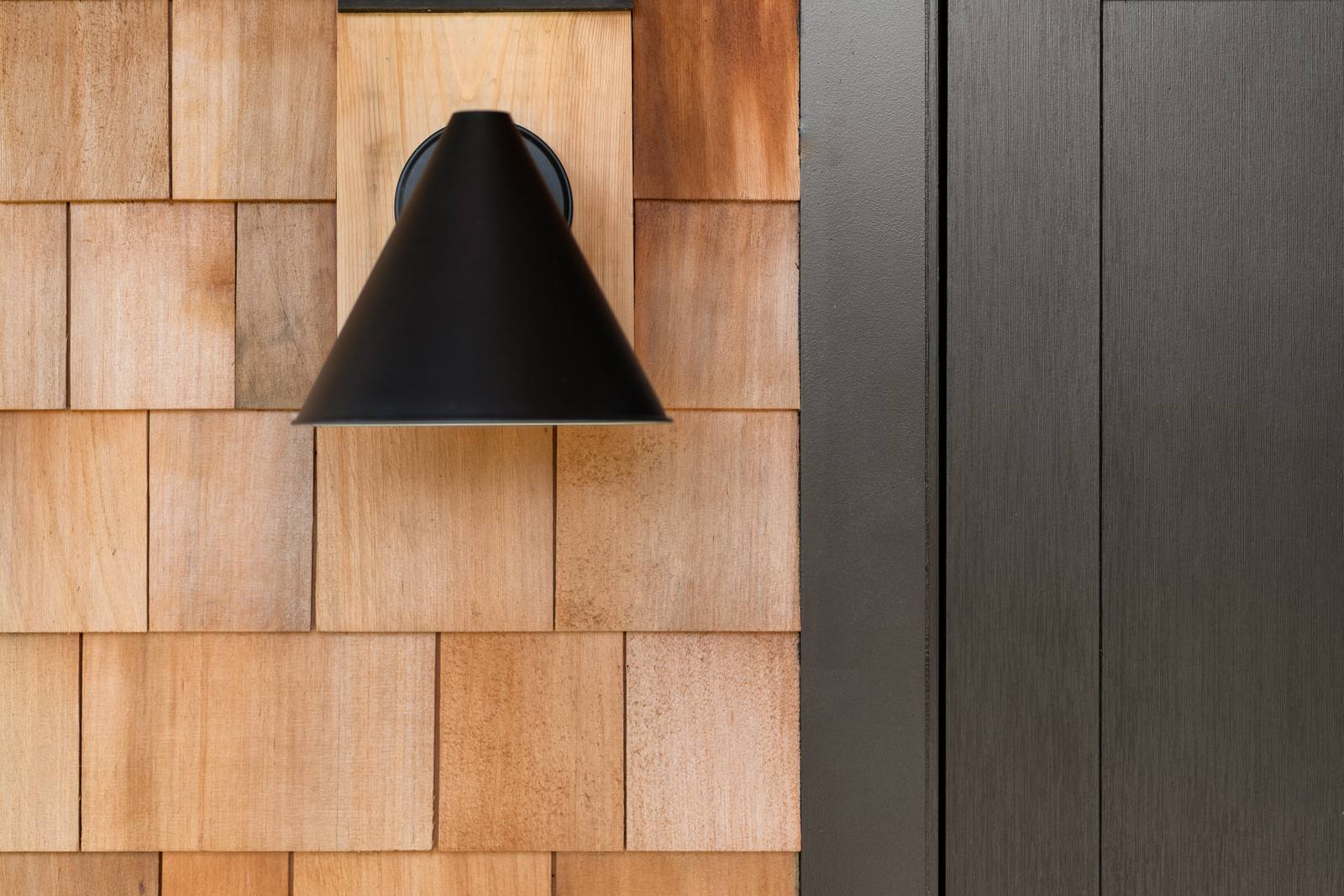house addition black barn light on cedar shingles guilford ct
