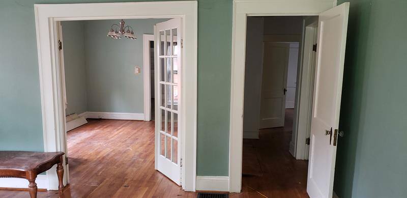 Open doorway between two rooms in a house undergoing remodeling by Craft Design + Build, Essex, Connecticut