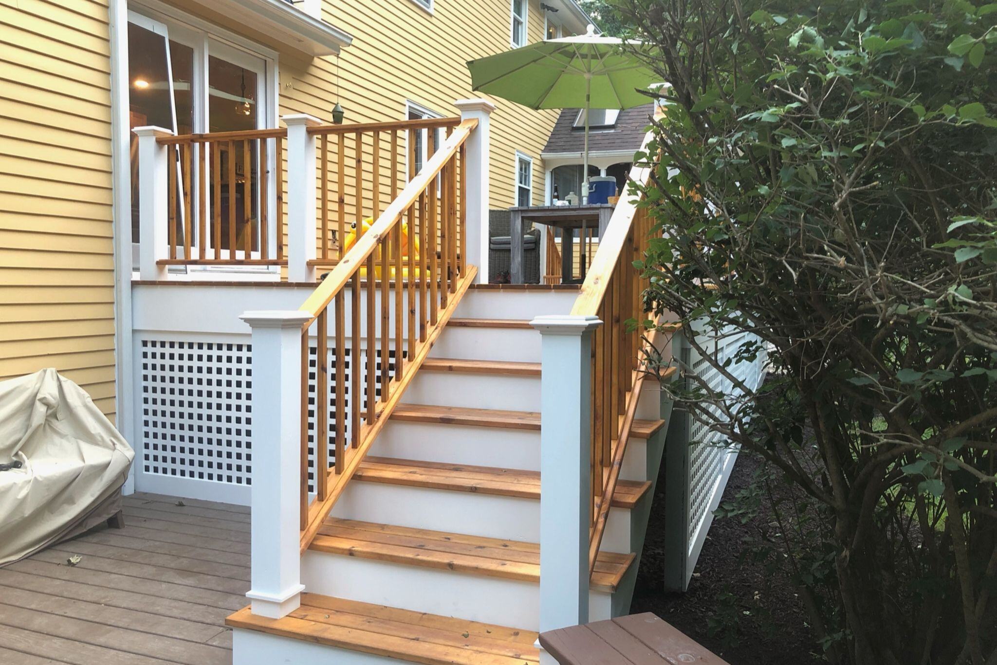 Outdoor living area renovation with wooden staircase deck in a Connecticut backyard